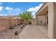 Backyard showcasing a covered patio with seating and a beautiful garden area at 7452 Chaffinch St, North Las Vegas, NV 89084