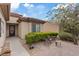 Inviting front entrance with decorative door, tiled patio and garden seating at 7452 Chaffinch St, North Las Vegas, NV 89084