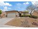 Attractive single-story home featuring a well-maintained desert landscape and neutral color scheme at 7452 Chaffinch St, North Las Vegas, NV 89084