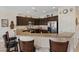 Stylish kitchen featuring dark cabinets, stainless steel appliances, and breakfast bar at 7452 Chaffinch St, North Las Vegas, NV 89084