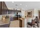Modern kitchen featuring granite countertops, dark cabinetry, and stainless steel appliances at 7452 Chaffinch St, North Las Vegas, NV 89084