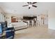 Open-concept living space with tile flooring, leading to a kitchen with bar seating at 7452 Chaffinch St, North Las Vegas, NV 89084