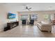 Bright living room with large windows, tile flooring, and neutral wall color at 7452 Chaffinch St, North Las Vegas, NV 89084