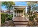 Covered backyard patio with lush landscaping and open space perfect for outdoor gatherings and relaxation at 810 Socorro Song Ln, Henderson, NV 89052