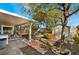 Backyard area featuring covered patio, storage shed, and mature trees, creating a private retreat at 810 Socorro Song Ln, Henderson, NV 89052