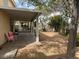 The covered patio has mature trees and space for relaxing and entertaining at 810 Socorro Song Ln, Henderson, NV 89052