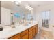 Bright bathroom features a double sink vanity, tile floors, and a bathtub and shower at 810 Socorro Song Ln, Henderson, NV 89052