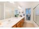 Bright bathroom features a double sink vanity and a shower and bathtub combo at 810 Socorro Song Ln, Henderson, NV 89052