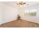 A bright bedroom with neutral carpet and paint, a ceiling fan, and a window at 810 Socorro Song Ln, Henderson, NV 89052