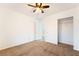 A carpeted bedroom featuring a ceiling fan and a closet with sliding doors at 810 Socorro Song Ln, Henderson, NV 89052