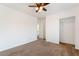 A carpeted bedroom with neutral carpet and paint, a ceiling fan, and a closet with sliding doors at 810 Socorro Song Ln, Henderson, NV 89052