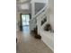 Inviting entryway with stylish staircase, white railing, and tile flooring leading to the living spaces at 810 Socorro Song Ln, Henderson, NV 89052
