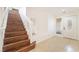 Inviting entryway with tile flooring, wooden staircase, and decorative front door at 810 Socorro Song Ln, Henderson, NV 89052