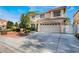 Attractive two-story home with a spacious driveway, two-car garage, and tidy landscaping adding curb appeal at 810 Socorro Song Ln, Henderson, NV 89052