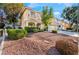 Charming home exterior with well-manicured landscaping, mature trees, and a cozy balcony on the second floor at 810 Socorro Song Ln, Henderson, NV 89052
