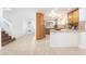 Open kitchen with tile flooring, updated cabinets, and stainless steel appliances at 810 Socorro Song Ln, Henderson, NV 89052