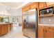 Spacious kitchen with stainless steel refrigerator, microwave, and an eat-in area at 810 Socorro Song Ln, Henderson, NV 89052