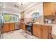 Well-lit kitchen with stainless steel appliances, wooden cabinets, and tile backsplash at 810 Socorro Song Ln, Henderson, NV 89052