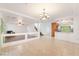 Bright living room with tile flooring, chandelier, and modern staircase at 810 Socorro Song Ln, Henderson, NV 89052