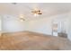 Large living room features neutral carpet, ceiling fans, and natural light at 810 Socorro Song Ln, Henderson, NV 89052