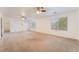 Expansive living room features neutral carpet, ceiling fans, and natural lighting at 810 Socorro Song Ln, Henderson, NV 89052