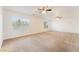 Spacious living room with neutral carpet, ceiling fans, and bright windows at 810 Socorro Song Ln, Henderson, NV 89052