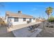 Spacious backyard featuring a desert landscape and two lounge chairs on the concrete patio at 823 Crabapple Dr, Henderson, NV 89002
