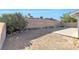 Spacious backyard with a concrete patio and desert landscaping near block wall at 823 Crabapple Dr, Henderson, NV 89002