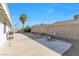 Spacious backyard featuring a desert landscape and two chairs on the concrete patio at 823 Crabapple Dr, Henderson, NV 89002