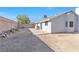 Spacious backyard with a concrete patio, desert landscaping, and block wall at 823 Crabapple Dr, Henderson, NV 89002