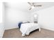 This bedroom offers neutral carpeting, a ceiling fan and ensuite bathroom access at 823 Crabapple Dr, Henderson, NV 89002