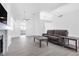 Spacious living room boasts an electric fireplace, neutral walls and gray hardwood floors at 823 Crabapple Dr, Henderson, NV 89002