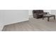 Bright living room featuring modern gray wood floors, neutral walls and a gray reclining love seat at 823 Crabapple Dr, Henderson, NV 89002