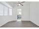 Bright living room with vaulted ceilings, ceiling fan and modern gray wood-look floors at 823 Crabapple Dr, Henderson, NV 89002