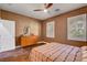 Bedroom featuring wood-look flooring, two windows and a wooden dresser at 8560 Alocasia Ct, Las Vegas, NV 89149
