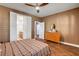 Bedroom features wood-look floors and access to the bathroom and hallways at 8560 Alocasia Ct, Las Vegas, NV 89149