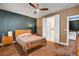Bedroom features wood-look floors and open closet leading to the laundry room at 8560 Alocasia Ct, Las Vegas, NV 89149
