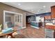 Open concept kitchen with stainless appliances, eat-in island, and access to the backyard at 8560 Alocasia Ct, Las Vegas, NV 89149
