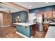 Kitchen features a center island, stainless steel appliances, and dark blue accent wall at 8560 Alocasia Ct, Las Vegas, NV 89149