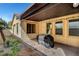 Relaxing covered patio featuring neutral colors and concrete flooring with outdoor lighting at 8560 Alocasia Ct, Las Vegas, NV 89149