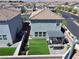 Backyard aerial view showcasing artificial turf, a patio with pergola and outdoor seating in a gated community at 8710 Beverly Grove Ct, Las Vegas, NV 89113