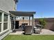 Relaxing backyard with a shaded pergola, comfortable seating, and well maintained artificial turf at 8710 Beverly Grove Ct, Las Vegas, NV 89113
