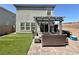 Outdoor oasis with artificial turf, brick patio and pergola shaded seating for relaxing and entertaining at 8710 Beverly Grove Ct, Las Vegas, NV 89113