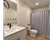 Well-lit bathroom with modern fixtures, a stylish vanity, and a shower with a neutral-toned curtain at 8710 Beverly Grove Ct, Las Vegas, NV 89113