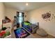 Bright bedroom with a bed, large gamer decal, and cool gamer decor at 8710 Beverly Grove Ct, Las Vegas, NV 89113