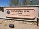 Community services sign for Exploration Peak Park with desert landscaping and trees at 8710 Beverly Grove Ct, Las Vegas, NV 89113