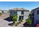 Two-story home boasts neutral stucco, tile roof, xeriscape landscaping, and a brick driveway at 8710 Beverly Grove Ct, Las Vegas, NV 89113
