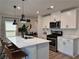 Modern kitchen with a spacious island, stainless steel appliances, and white cabinets at 8710 Beverly Grove Ct, Las Vegas, NV 89113