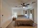 Cozy main bedroom with neutral tones, a ceiling fan, and natural light at 8710 Beverly Grove Ct, Las Vegas, NV 89113