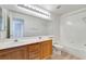Bathroom featuring dual sinks, a vanity with wood finish, and a bathtub, perfect for everyday use at 9785 Gallo Dr, Las Vegas, NV 89147